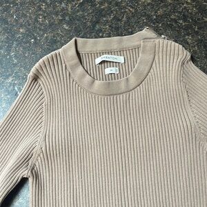 Babaton long sleeved ribbed sweater, sits at or below waist.